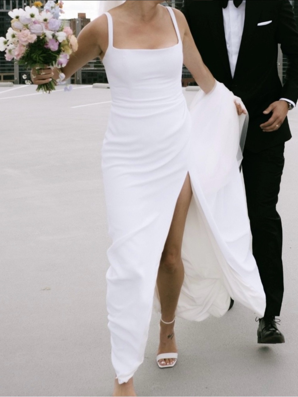 Alyssa Kristen Gemma dress with pleated skirt and high slit.